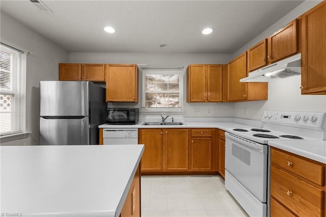 kitchen featuring white appliances and sink