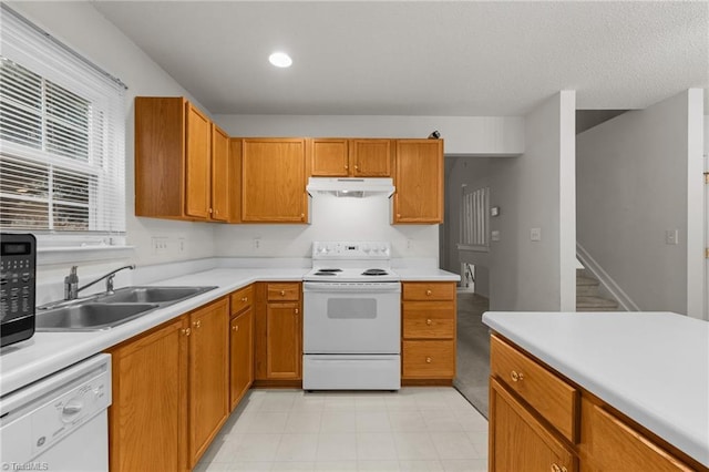 kitchen featuring white appliances and sink