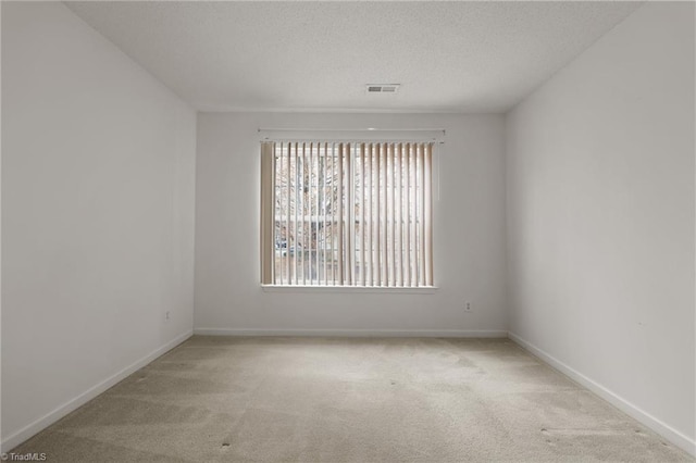 unfurnished room with light carpet