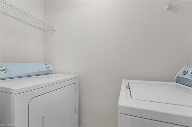 clothes washing area featuring independent washer and dryer