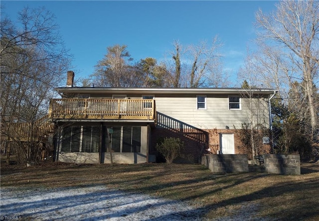 rear view of house featuring a wooden deck