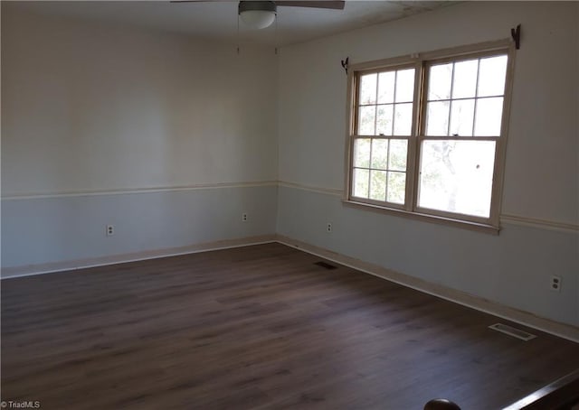 spare room with ceiling fan and dark hardwood / wood-style floors