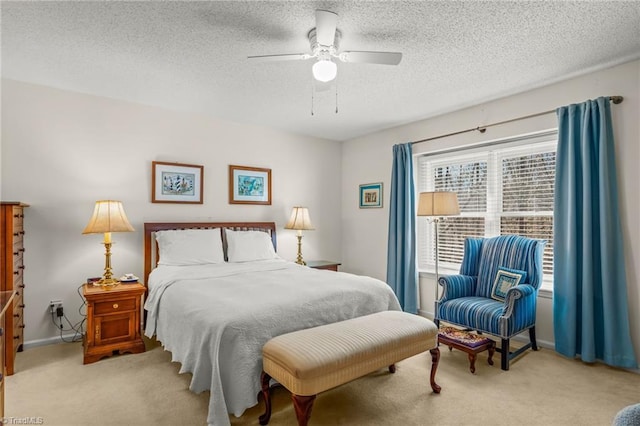 bedroom with carpet floors, ceiling fan, a textured ceiling, and baseboards