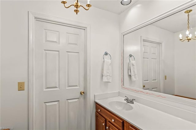 bathroom featuring vanity and a notable chandelier