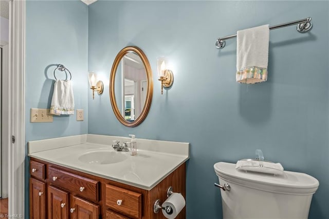 half bathroom featuring toilet and vanity