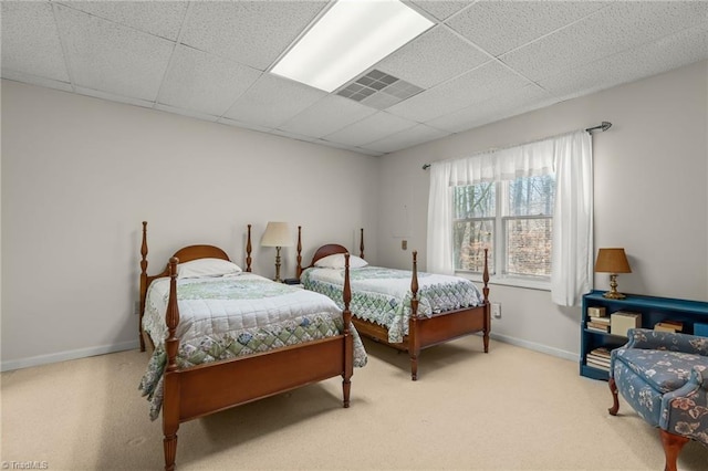 bedroom featuring a paneled ceiling, carpet flooring, visible vents, and baseboards