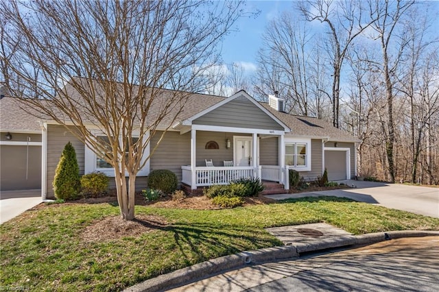 ranch-style house featuring driveway, a chimney, an attached garage, covered porch, and a front lawn