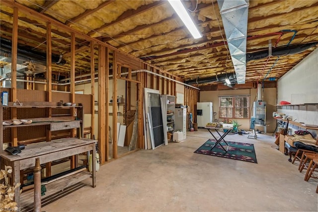 basement with white refrigerator with ice dispenser and gas water heater