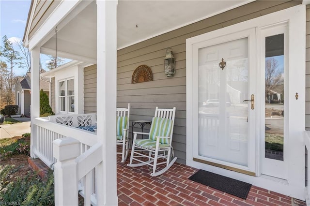 view of exterior entry featuring a porch