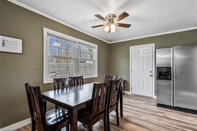 dining area featuring ornamental molding, ceiling fan, and light hardwood / wood-style floors