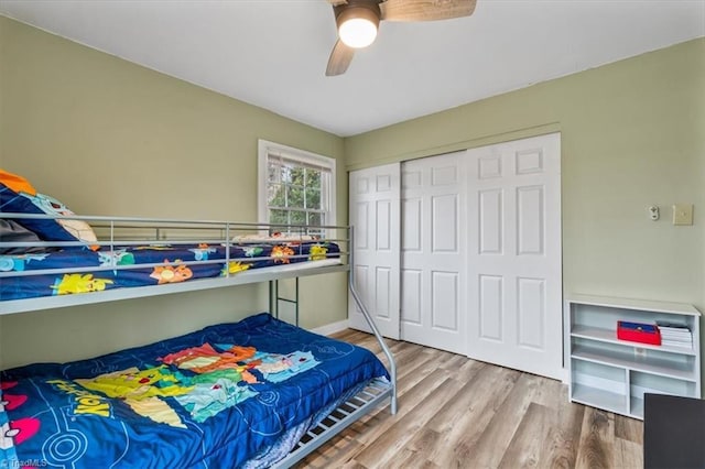 bedroom with hardwood / wood-style flooring, a closet, and ceiling fan