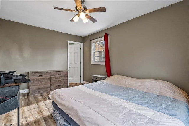 bedroom featuring hardwood / wood-style flooring and ceiling fan