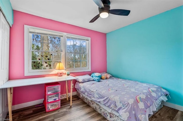 bedroom with ceiling fan, wood-type flooring, and a closet