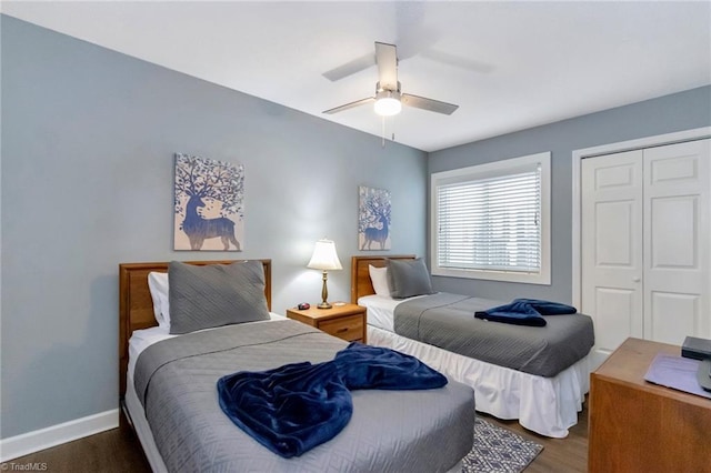 bedroom featuring ceiling fan, a closet, and dark wood-type flooring