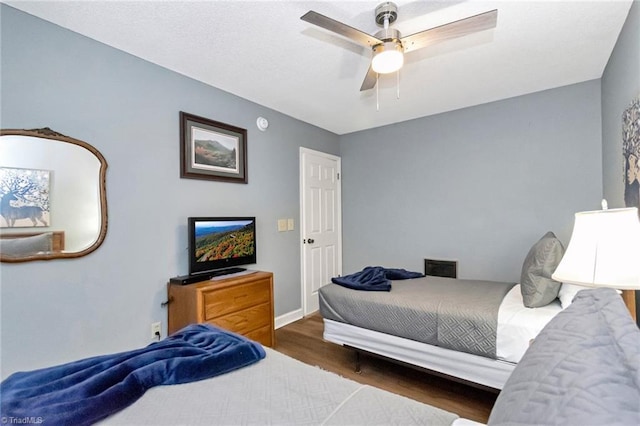 bedroom featuring ceiling fan and dark hardwood / wood-style flooring