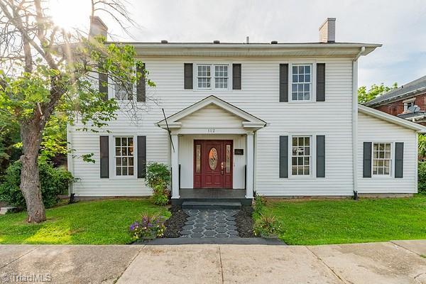 112 S Caldwell St, Salisbury, NC 28144 - colonial home featuring a chimney and a front lawn