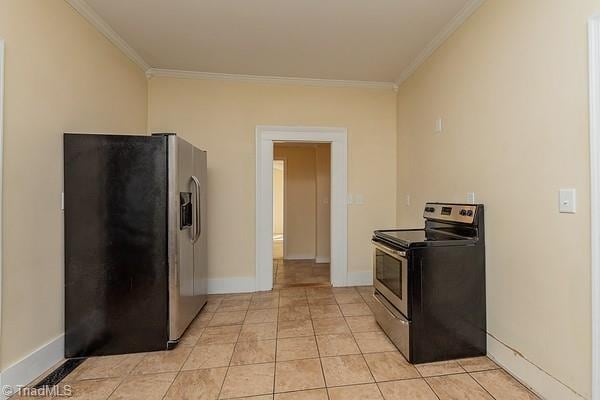 112 S Caldwell St, Salisbury, NC 28144 - kitchen featuring stainless steel appliances, crown molding, baseboards, and light tile patterned flooring