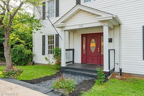 112 S Caldwell St, Salisbury, NC 28144 - view of exterior entry with a yard