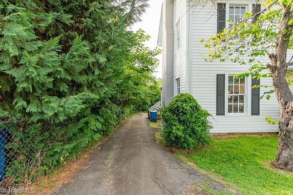 112 S Caldwell St, Salisbury, NC 28144 - view of property exterior featuring asphalt driveway and central AC unit