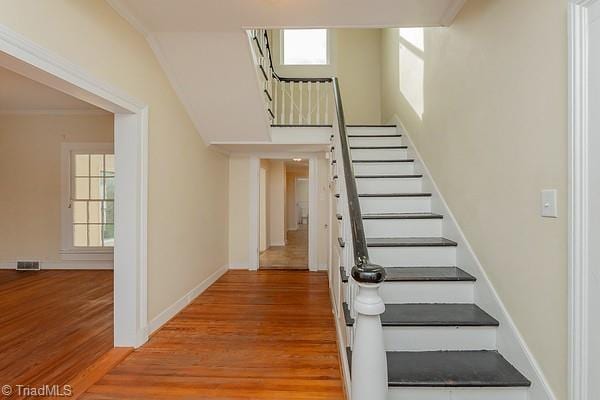 112 S Caldwell St, Salisbury, NC 28144 - staircase with wood finished floors, baseboards, and crown molding