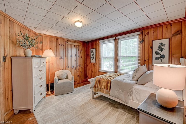 bedroom featuring wooden walls