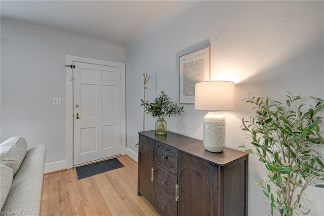 foyer featuring baseboards and light wood-style floors