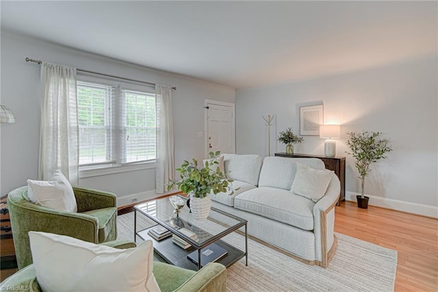 living area with light wood finished floors and baseboards