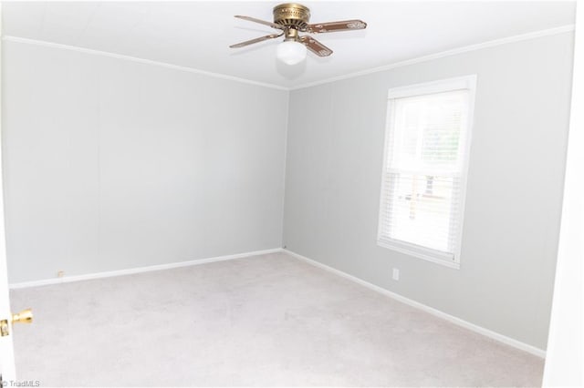 spare room with light carpet, a healthy amount of sunlight, and crown molding