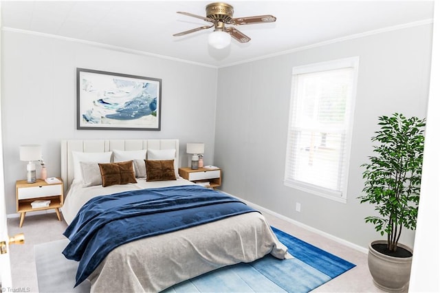 carpeted bedroom with ceiling fan and ornamental molding