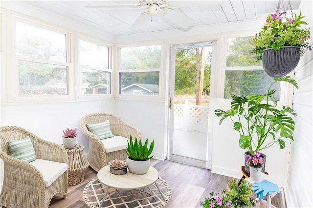 sunroom featuring ceiling fan