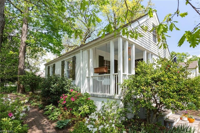 view of property exterior featuring covered porch