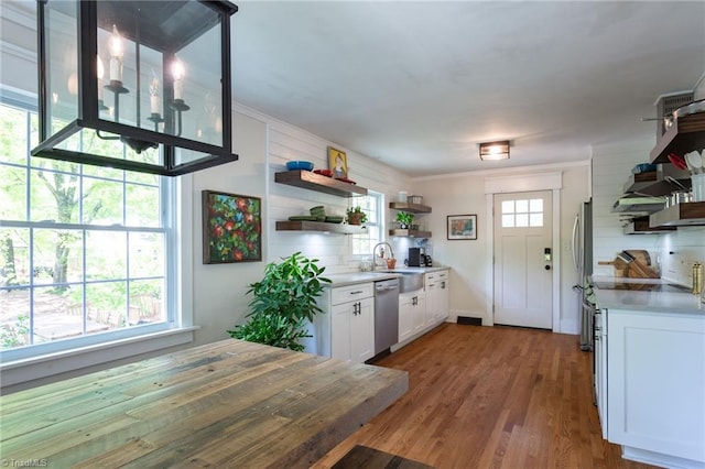 kitchen with open shelves, appliances with stainless steel finishes, a sink, white cabinetry, and light countertops