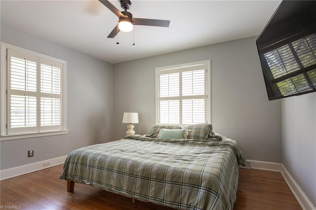 bedroom with baseboards, wood finished floors, and ceiling fan