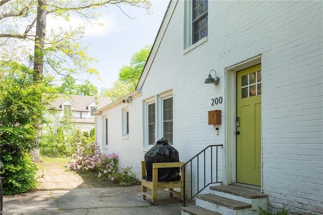 property entrance featuring brick siding