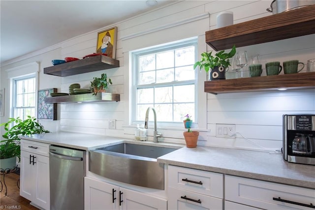 kitchen with open shelves, a sink, stainless steel dishwasher, white cabinetry, and ornamental molding