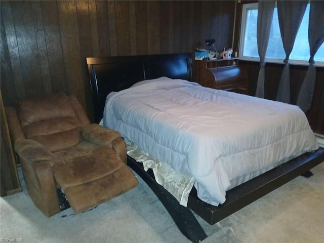 bedroom featuring carpet and wood walls