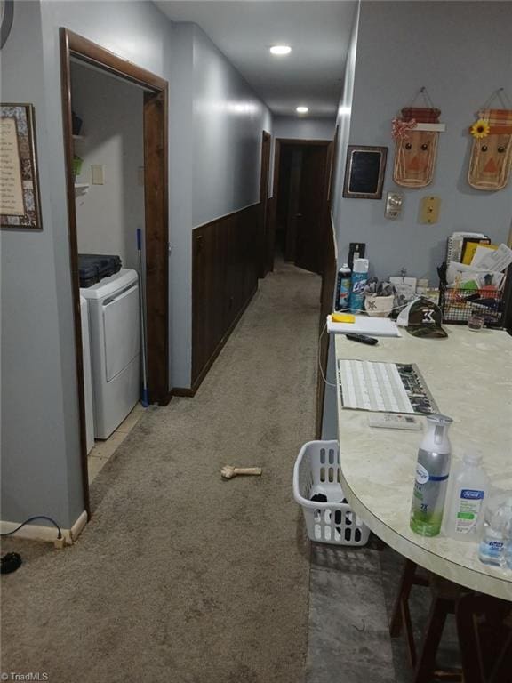 hallway featuring washer / clothes dryer and light colored carpet