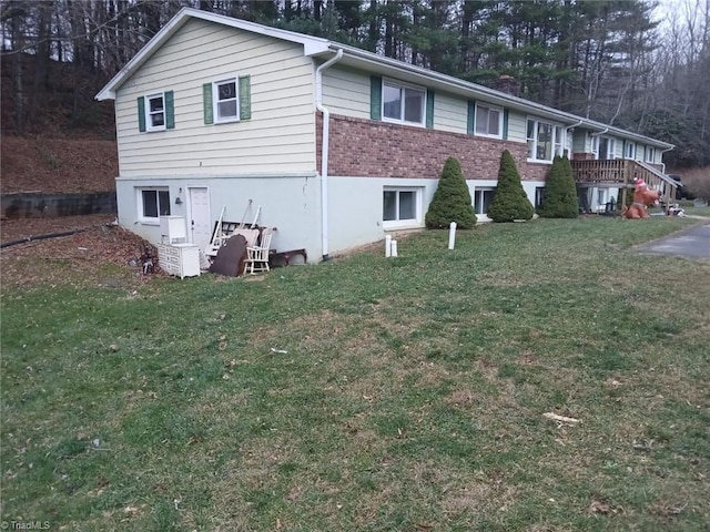 view of side of property with a yard