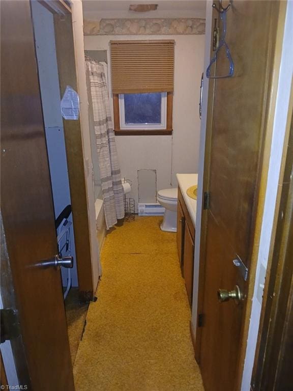 full bathroom featuring vanity, toilet, a baseboard heating unit, and shower / tub combo with curtain