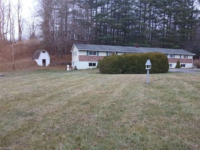 view of front of property with a shed and a front yard