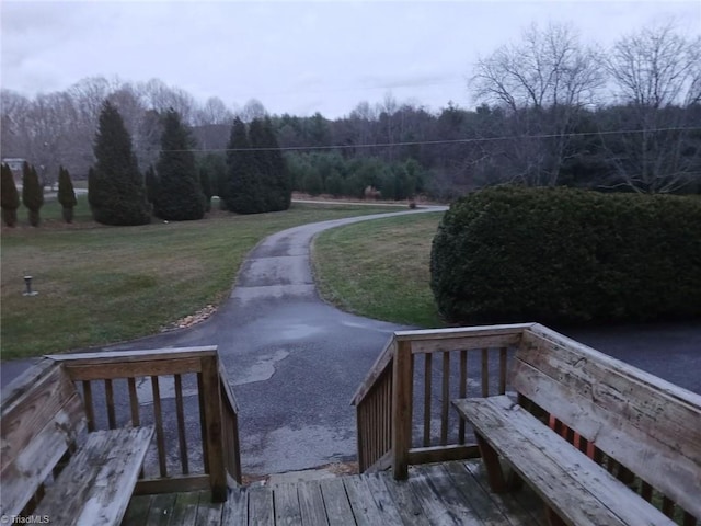 view of property's community featuring a yard and a wooden deck