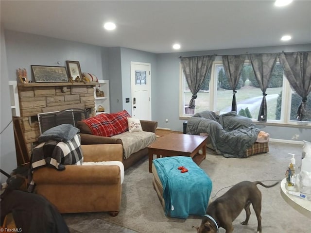 living room featuring a stone fireplace