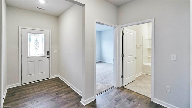 entryway with dark hardwood / wood-style flooring