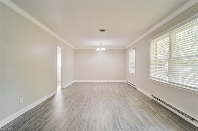 spare room with a chandelier, dark hardwood / wood-style flooring, a baseboard radiator, and ornamental molding