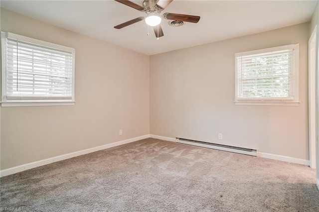 empty room with carpet floors, a baseboard radiator, and ceiling fan