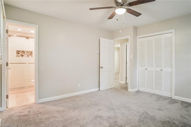 unfurnished bedroom with carpet flooring, a closet, ensuite bath, and ceiling fan