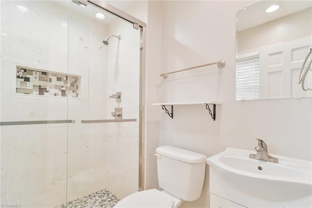 bathroom featuring vanity, toilet, and walk in shower