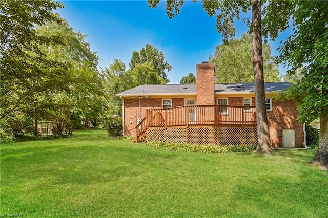 back of property with a lawn and a deck