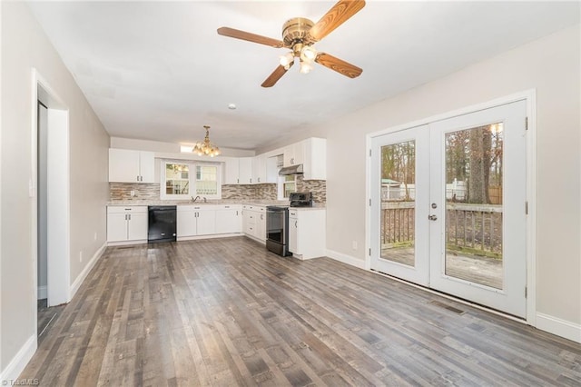 kitchen with french doors, white cabinets, electric stove, black dishwasher, and a wealth of natural light