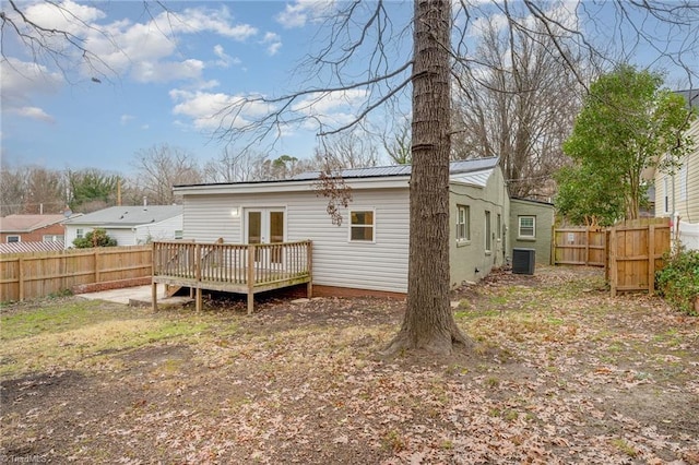 back of property with french doors, cooling unit, and a wooden deck